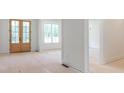 Bright interior space with pristine white walls, double doors, and large windows offering ample natural light at 410 Iroquois Ct, Covington, GA 30014