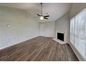 Bright living room with a fireplace, wood floors, and vaulted ceiling at 155 Fairclift Dr, Covington, GA 30016