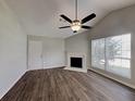 Bright living room featuring a fireplace, wood floors, and vaulted ceiling at 155 Fairclift Dr, Covington, GA 30016