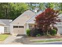 View of the front of the property showcasing the well-kept lawn and partial two car garage at 5069 Kathryn Glen Dr, Acworth, GA 30101