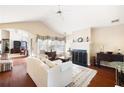 Bright living room with hardwood floors, fireplace, ceiling fan, and elegant furnishings at 5069 Kathryn Glen Dr, Acworth, GA 30101