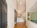 Bright entryway with hardwood floors, staircase, and soaring ceilings provides a welcoming entrance at 1765 Redbud Way, Cumming, GA 30041