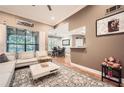 Spacious living room featuring hardwood floors, neutral walls, and large windows overlooking trees at 3777 Peachtree Ne Rd # 438, Brookhaven, GA 30319