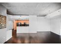 Bright living area showcasing hardwood floors, an open-concept kitchen and modern lighting at 3324 Peachtree Ne Rd # 2718, Atlanta, GA 30326