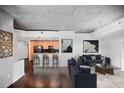 Bright, open-concept space with modern furniture, dark floors, and a view of the kitchen at 3324 Peachtree Ne Rd # 2718, Atlanta, GA 30326