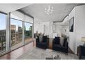 Modern living space featuring city views, wood floors, neutral decor, and access to a balcony at 3324 Peachtree Ne Rd # 2718, Atlanta, GA 30326