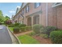 A row of charming brick townhomes with manicured front lawns and covered entries at 1950 Buford Dam Rd # 205, Cumming, GA 30041