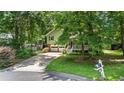 Charming home on a tree-lined street, featuring a two-car garage and a cozy front porch at 3627 Spring Meadow Court, Acworth, GA 30101