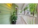 Inviting front porch with a green exterior and a view of the surrounding landscape at 3627 Spring Meadow Court, Acworth, GA 30101
