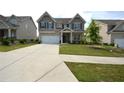 Charming two-story home with a well-manicured lawn and a large driveway at 7753 Hansel Ln, Lithonia, GA 30058