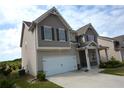 Side view of a charming two-story home with a well-manicured lawn at 7753 Hansel Ln, Lithonia, GA 30058
