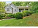 Charming single-story home with a covered front porch and well-maintained landscaping at 144 Wiley Dr, Douglasville, GA 30134