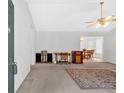 Neutral living room featuring ceiling fan, and a view of dining area with lots of light at 144 Wiley Dr, Douglasville, GA 30134