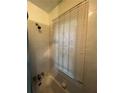 Bathroom featuring a shower/tub combo with tiled walls and natural light from the window at 1750 Beechwood Sw Blvd, Atlanta, GA 30311