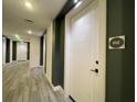 Well-lit hallway with gray wood flooring, white doors and modern design at 788 W Marietta Nw St # 512, Atlanta, GA 30318