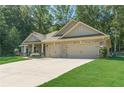 Charming single story brick home featuring an attached two car garage and a long driveway at 150 Whitworth Dr, Locust Grove, GA 30248