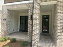 Inviting front porch with brick flooring, offering a cozy entrance to the townhome at 358 Olmstead Way # 25, Alpharetta, GA 30022