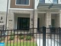 Charming front porch of a townhome, featuring brick accents and covered entryways at 358 Olmstead Way # 25, Alpharetta, GA 30022