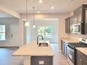 Kitchen island with stainless steel sink and granite countertops at 4849 Walkers Green, Mableton, GA 30126
