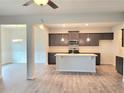 Open concept kitchen with stainless appliances, granite countertops, and gray cabinets at 4849 Walkers Green, Mableton, GA 30126
