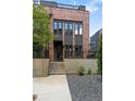 Beautiful brick townhome showcasing a modern exterior with large windows, black trim and minimalist landscaping at 1244 Chelsea Nw Cir, Atlanta, GA 30318