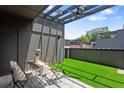 Charming rooftop terrace with artificial grass, stylish furniture, and a pergola for shade at 1244 Chelsea Nw Cir, Atlanta, GA 30318