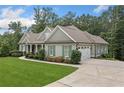 Well-maintained home featuring a side-entry garage and lush landscaping at 208 Wilshire Ter, White, GA 30184