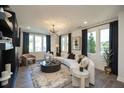 Bright living room with large windows, a comfortable sofa, and modern decor at 392 Pratt Dr # 2014, Atlanta, GA 30315