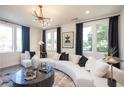 Inviting living room with modern decor, large windows, and stylish lighting at 392 Pratt Dr # 2014, Atlanta, GA 30315