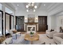 Elegant living room showcasing built-in cabinetry, a fireplace, and refined decor at 821 Camden Park Ct, Atlanta, GA 30342