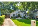 Charming home with well-manicured lawn, mature trees, and a private driveway at 135 Martha Ne Ave, Atlanta, GA 30317