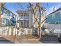 Charming two-story home features a welcoming front porch and a classic white picket fence at 320 Harden St, Atlanta, GA 30312