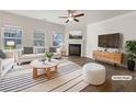 Bright living room with fireplace, hardwood floors, and ample natural light; virtually staged at 36 Crescent, Dallas, GA 30157