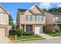 Charming home exterior featuring tan siding, brick accents, and a well-manicured lawn in a friendly neighborhood at 368 Rankin Cir, Mcdonough, GA 30253