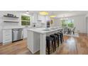 Modern, eat-in kitchen with stainless steel appliances, white cabinets, and hardwood flooring at 3710 Country Estate Dr Nw, Kennesaw, GA 30152
