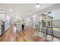 Bright, open kitchen featuring stainless steel appliances, white cabinets and hardwood floors at 3710 Country Estate Dr Nw, Kennesaw, GA 30152