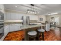 Modern kitchen featuring stainless steel appliances, an island with seating, and wood flooring at 2610 Links End, Roswell, GA 30076