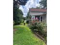 Charming home featuring a well-manicured front yard with lush greenery and beautiful flowers at 702 Moon Rd, Lawrenceville, GA 30046