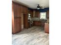 Kitchen featuring dark wood cabinetry, stainless steel appliances, granite countertops, and modern flooring at 702 Moon Rd, Lawrenceville, GA 30046
