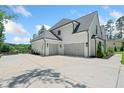 Spacious three-car garage with a large driveway and ample parking space at 103 Maddox Rd, Buford, GA 30518