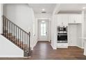 Inviting entryway with wood flooring, stairs, and access to kitchen appliances at 4778 Moonstone Trce, Kennesaw, GA 30144