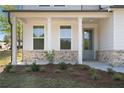 Charming front porch with brick accents, columns, and manicured landscaping at 4778 Moonstone Trce, Kennesaw, GA 30144