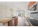 Modern kitchen with granite countertops, stainless steel appliances, and open layout to the living area at 711 Cosmopolitan Ne Dr # 802, Atlanta, GA 30324