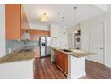 Stylish kitchen featuring granite countertops, stainless steel appliances, island and convenient laundry at 711 Cosmopolitan Ne Dr # 802, Atlanta, GA 30324