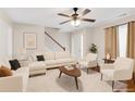 Inviting living room featuring hardwood floors, comfortable seating, and neutral wall colors at 5807 Mitchell Chase Trl, Mableton, GA 30126