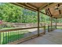 Inviting covered patio with view of fenced backyard and lush landscaping at 161 Old Vandiver Dr, Canton, GA 30114