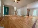 Bright and airy living room with hardwood floors, a vaulted ceiling, and an attractive front door at 48 Glenhaven Ct, Douglasville, GA 30134