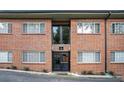 Exterior view of a well maintained brick apartment building with black door at 1705 Monroe Ne Dr # E3, Atlanta, GA 30324