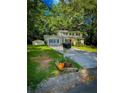 Charming two-story home featuring lush green lawn, mailbox with colorful flowers, and lovely trees surrounding the property at 287 Willow Cove Ct, Lawrenceville, GA 30044