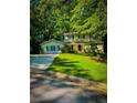 Charming two-story home featuring lush green lawn, classic black shutters, and lovely trees surrounding the property at 287 Willow Cove Ct, Lawrenceville, GA 30044